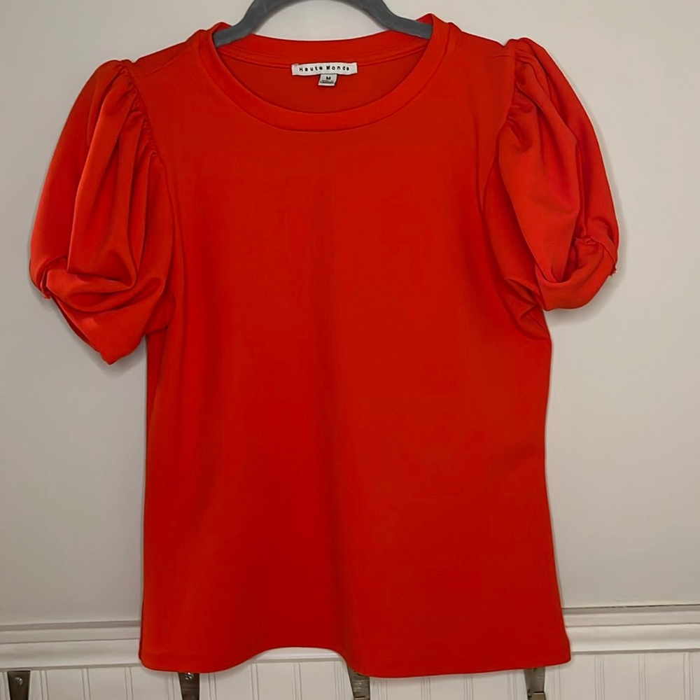 Haute Monde rounded neck blouse. Knot detail on short sleeves. Coral orange red.
